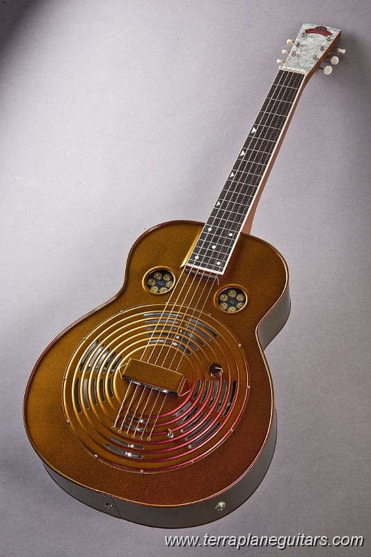 Centerfold-2.jpg - The special brass alloy used to fabricate these instruments creates a big warm tone. No other resonator guitar has the bass response of a .44 Special.